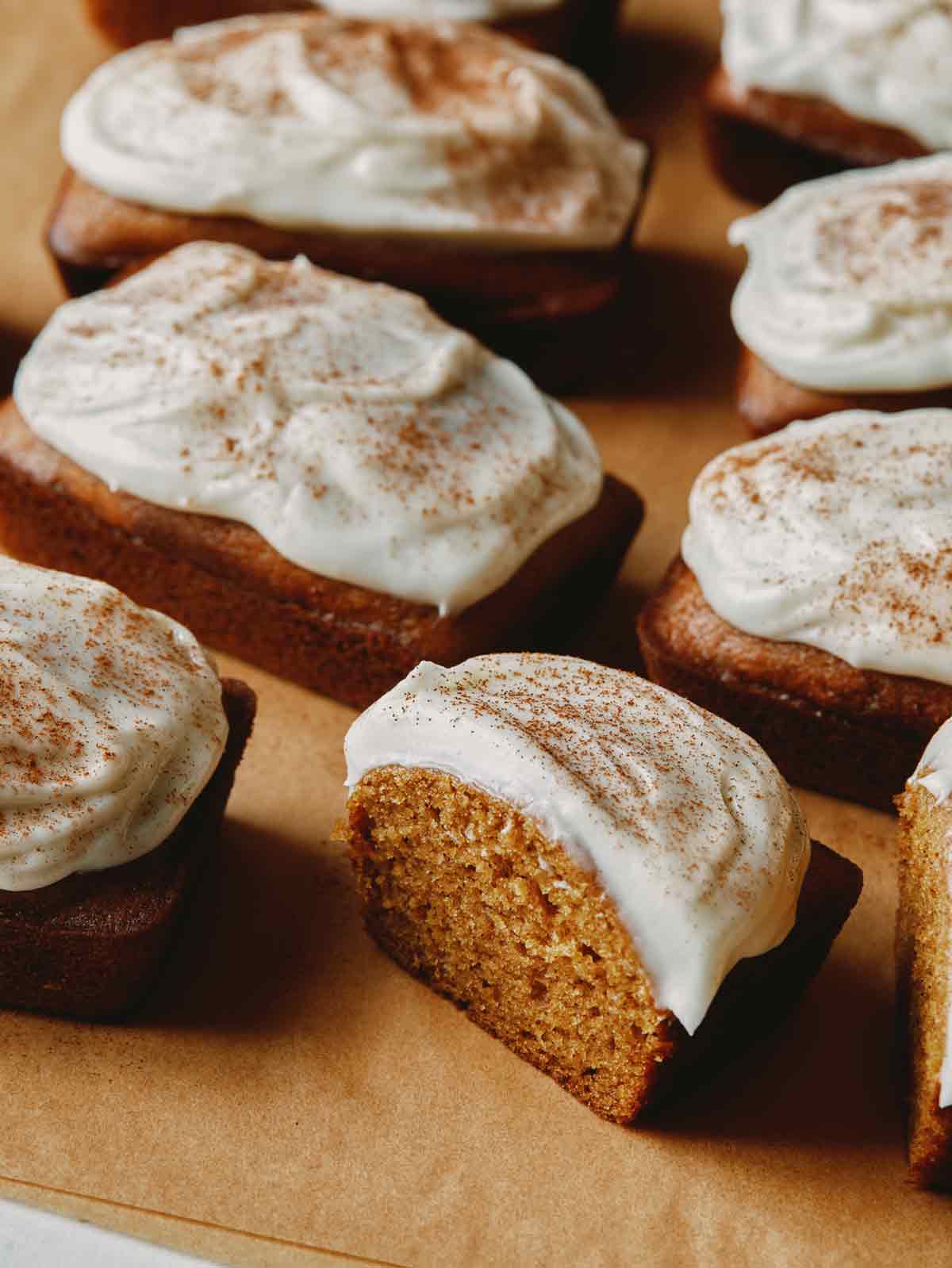 Pumpkin Bars with one cut in half on parchment.
