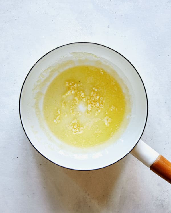 Butter with garlic in a sauce plan.