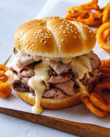 Roast beef sandwich with curly fries on the side.
