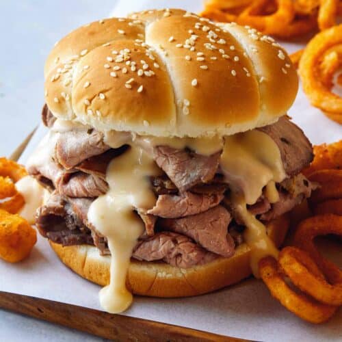 Roast beef sandwich with curly fries on the side.