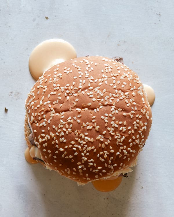 Overhead shot of a roast beef sandwich with cheese.