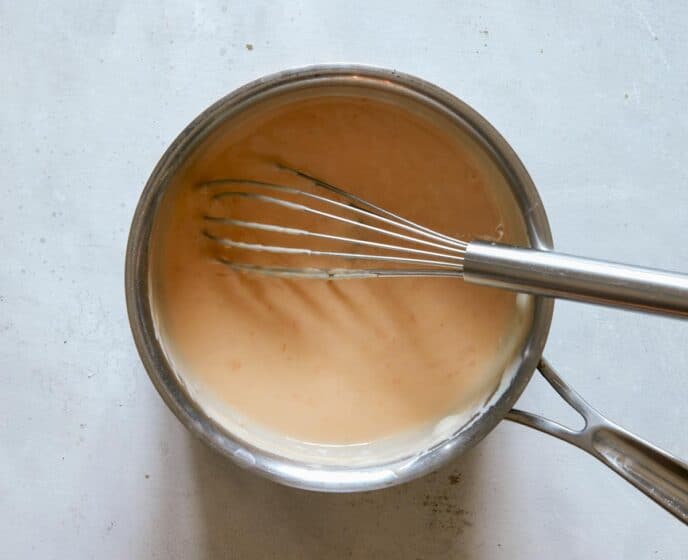 Cheese sauce in a pot for roast beef sandwich.