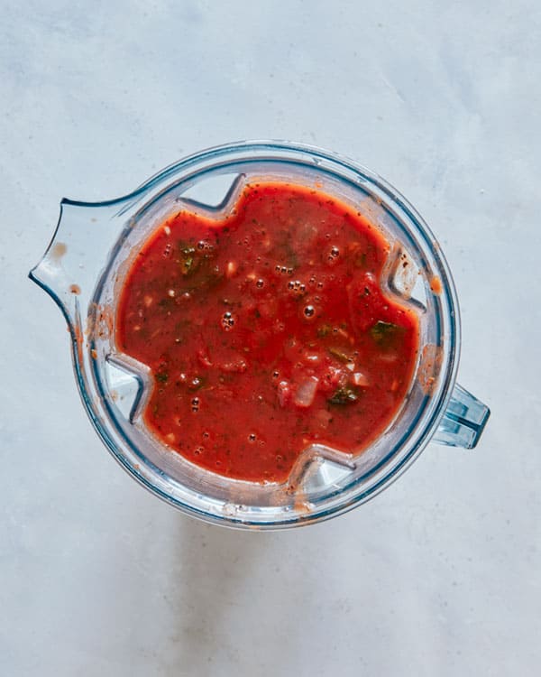 Tomato soup in a blender about to be blended. 