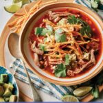 Tortilla soup in a bowl ready to be eaten.