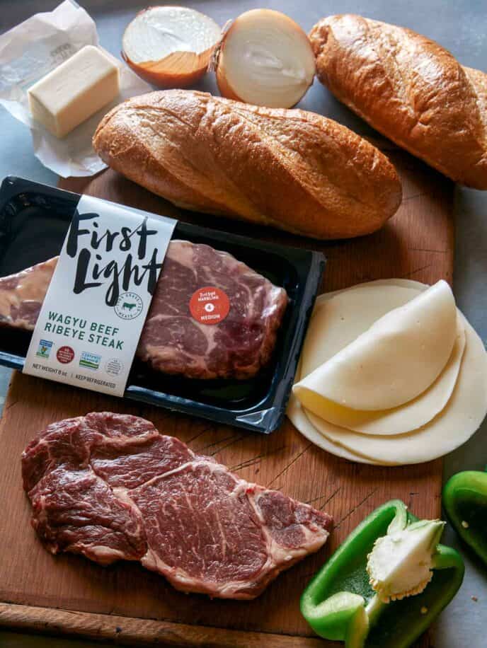 Ingredients to make a Philly Cheesesteak sandwich in a kitchen.