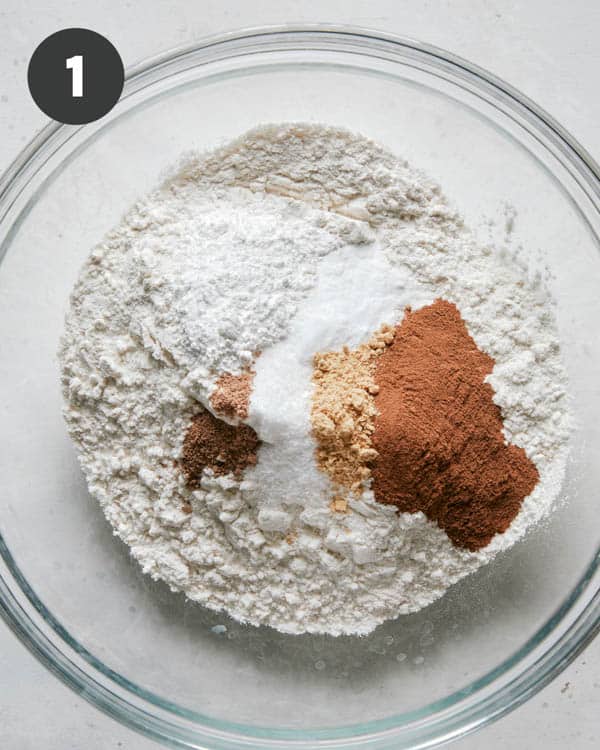 Dry ingredients in a glass bowl to make pumpkin bars.