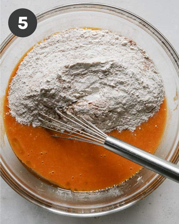 Combining dry and wet ingredients to make the batter for pumpkin bars.