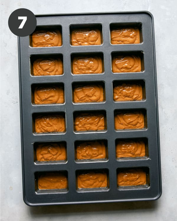 Pumpkin bar batter poured into a prepared baking sheet.