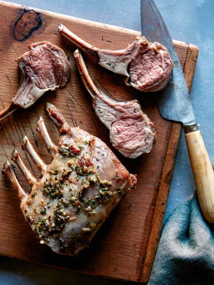 Cooked rack of lamb being sliced. 