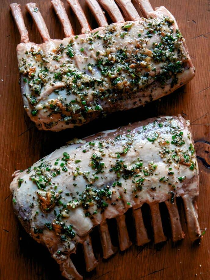 Rack of lamb with herbs rubbed on it.