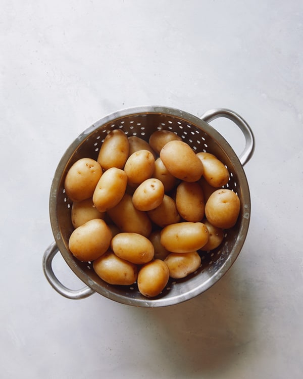 Cooked potatoes in a colander.