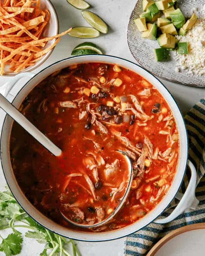 Carnitas soup recipe being served into bowls. 