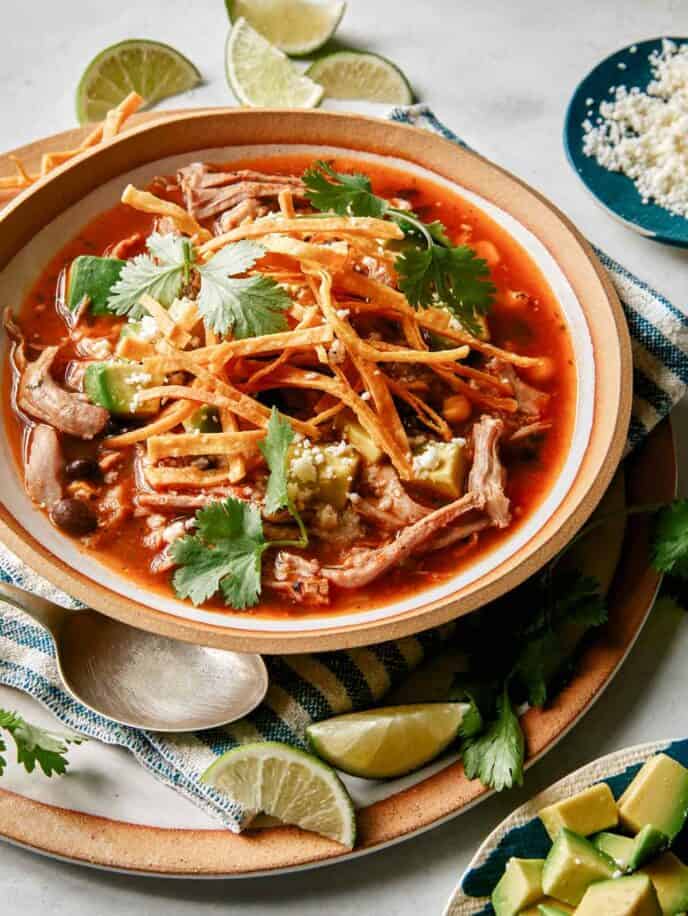 Tortilla soup in a bowl ready to be eaten.