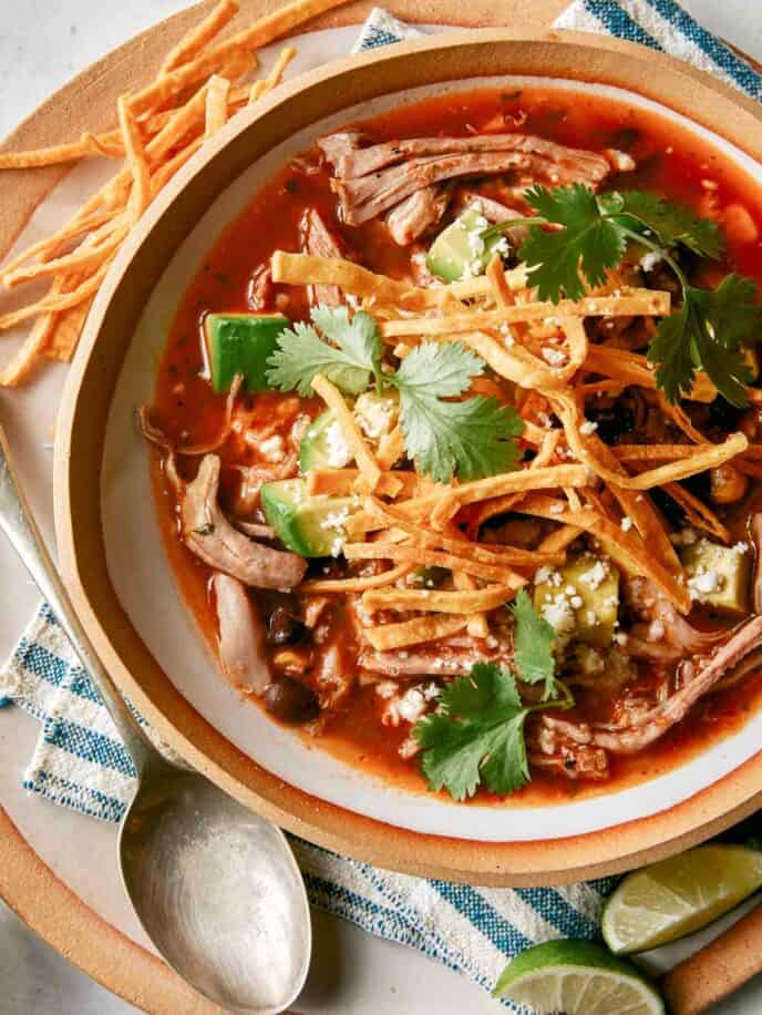 Carnitas soup in a bowl overhead. 