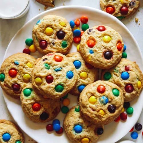 M&M cookie recipe on a plate with milk on the side.