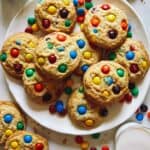 M&M Cookie recipe on a plate with milk.