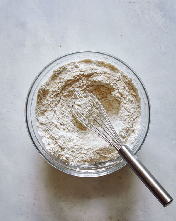 Dry ingredients mixed together in a glass bowl. 