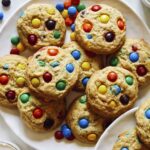 M&M Cookie recipe on a plate with milk.