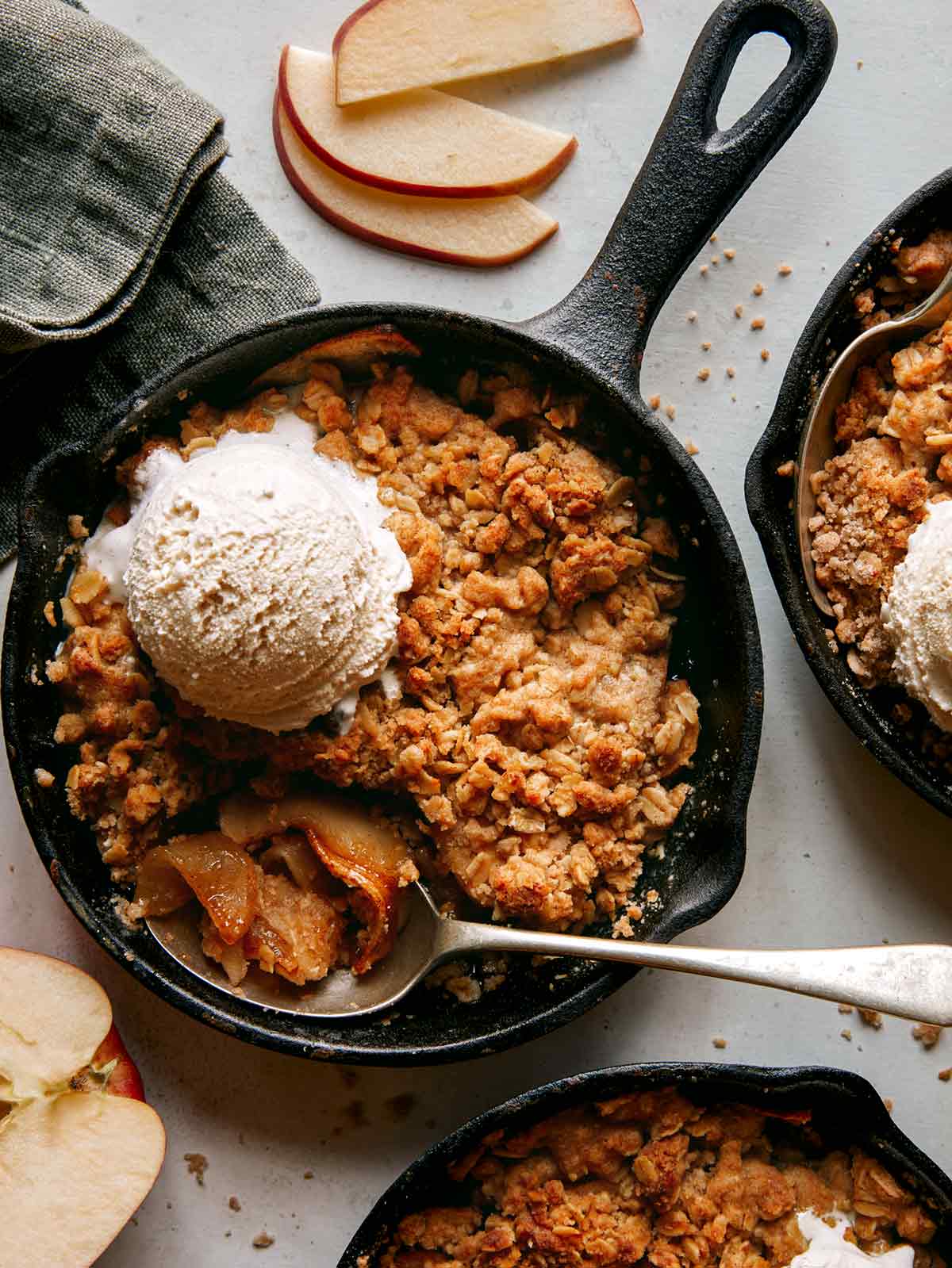 Apple crisps being eaten with apple slices on the side. 