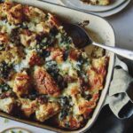 Sausage Strata recipe in a casserole dish with a scoop taken out.