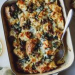 Sausage strata recipe in a baking dish with a scoop taken out.