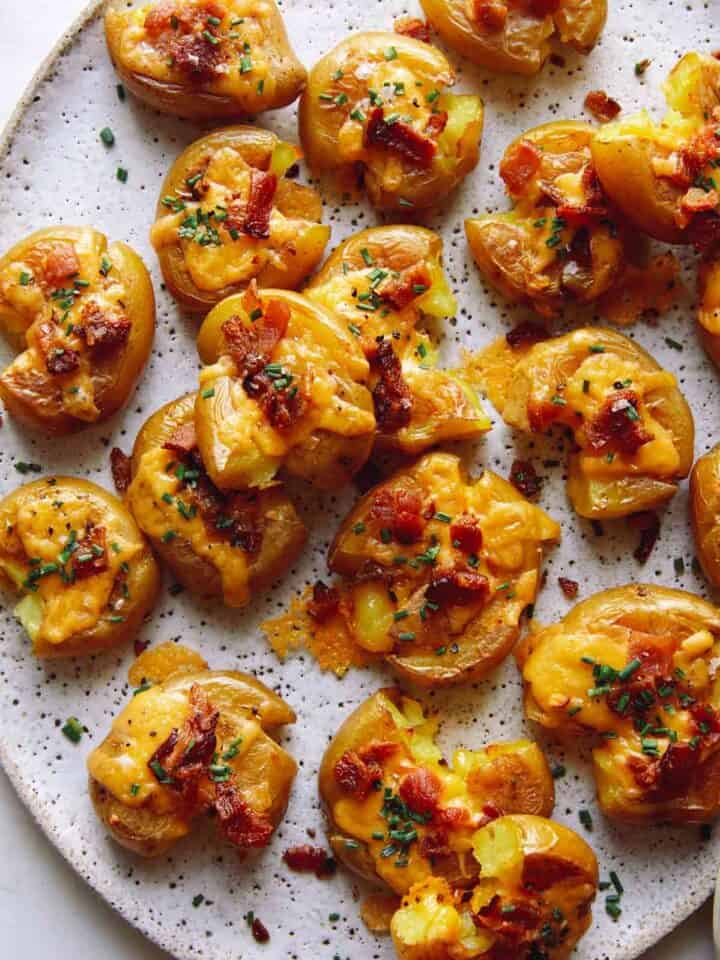 Close up on smashed potatoes on a platter.