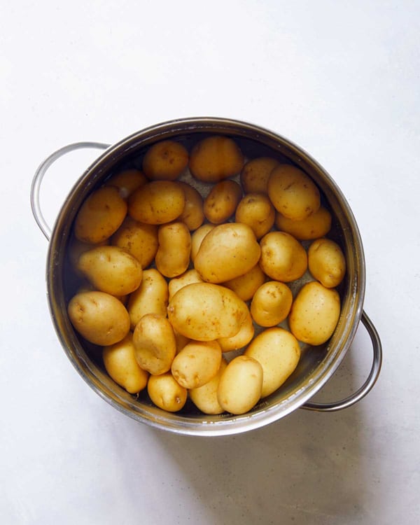 Potatoes in a pot of water to be boiled.