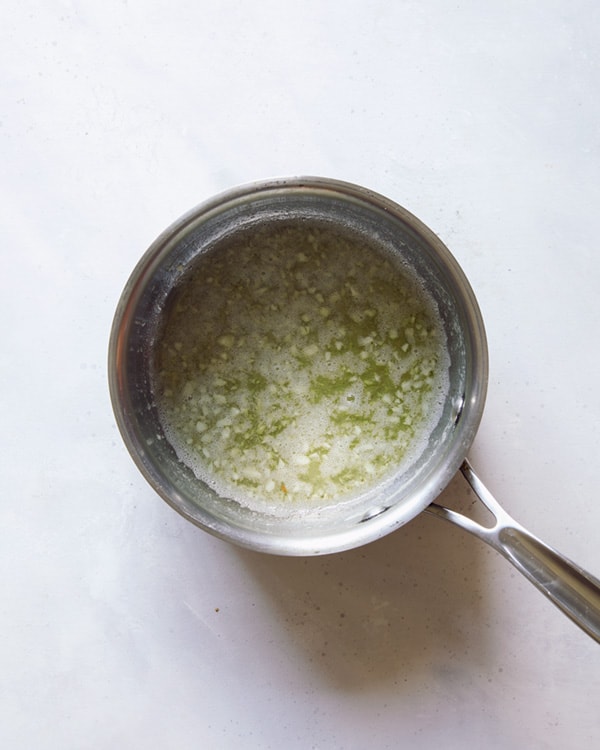 Butter melted in a saucepan with garlic.