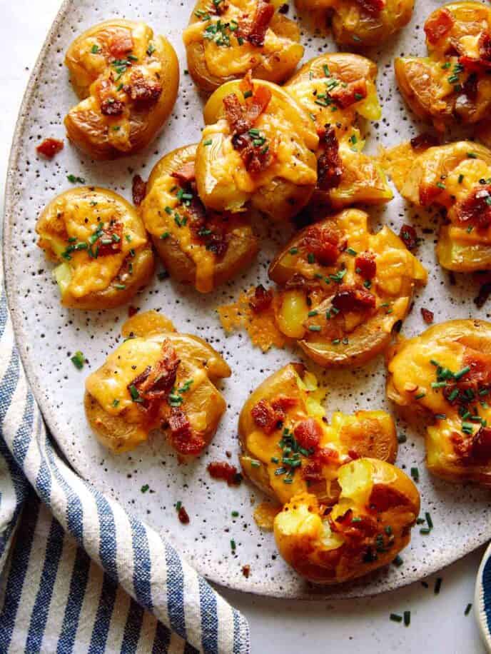 Smashed potatoes on a plate.