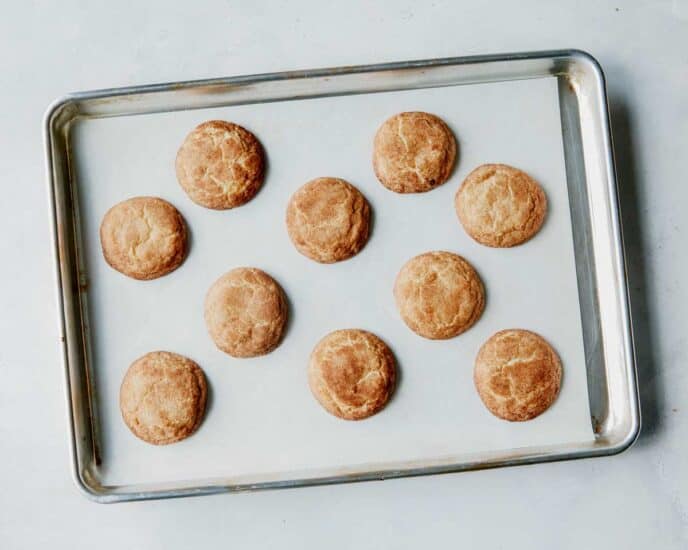 Snickerdoodle cookies baked on a baking sheet.