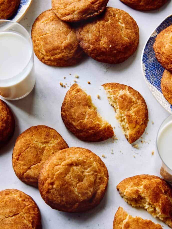 Snickerdoodle cookies recipe on plates with milk.