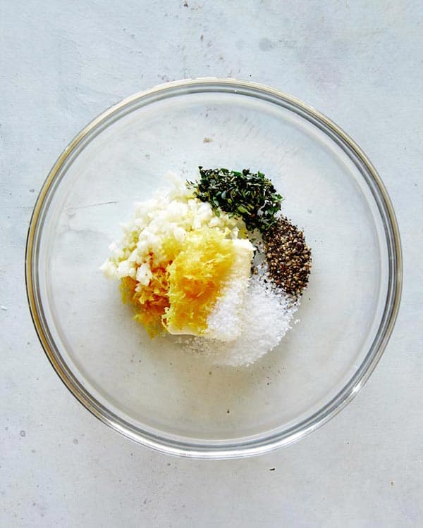 Butter and herbs in a glass bowl for Spatchcock chicken.