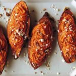 Close up on twice baked sweet potatoes on a plate.