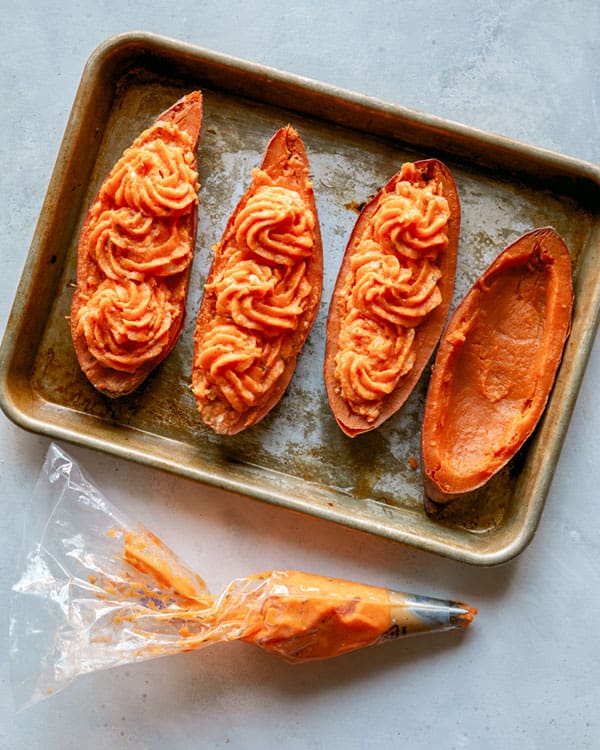 Piping twice baked sweet potatoes in their skins.