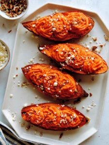 Twice baked sweet potatoes with feta and pecans on the side.