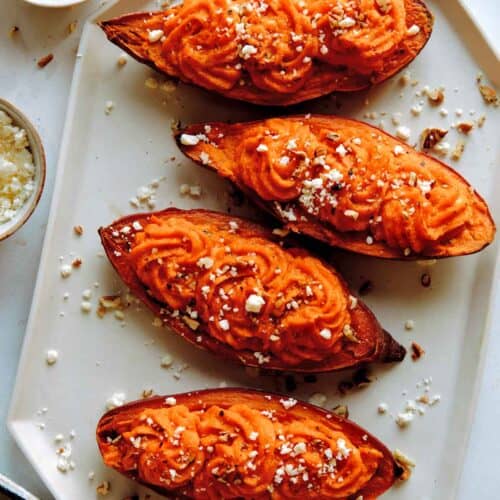 Twice baked sweet potatoes with feta and pecans on the side.