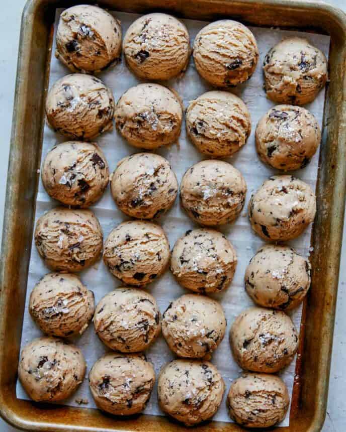 Chocolate chip cookie dough on a baking sheet. 