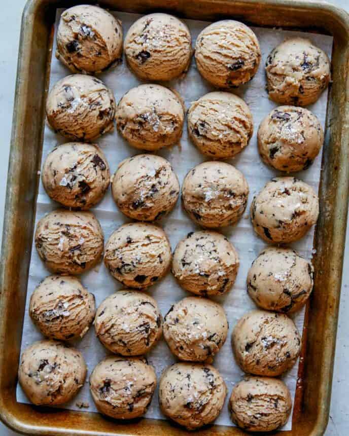 Chocolate chip cookie dough on a baking sheet.