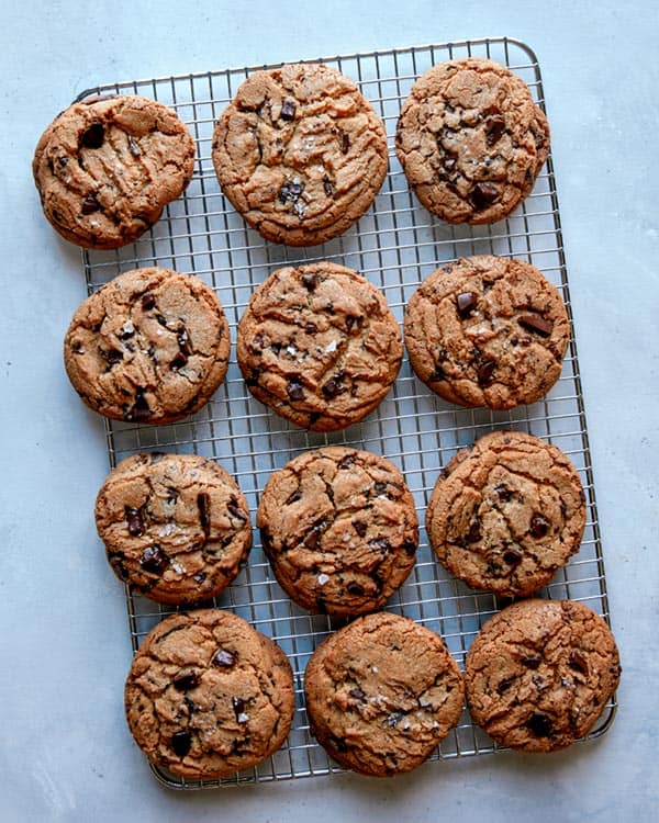 Chocolate chip cookies cooling on a wire rack.