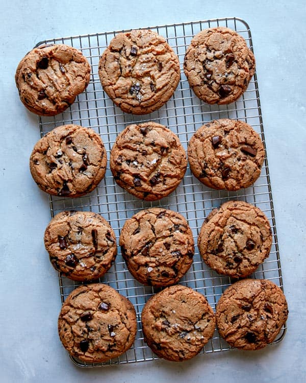 Chocolate chip cookies cooling on a wire rack. 