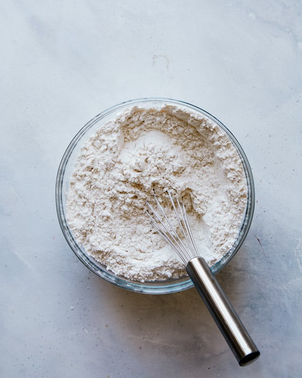 Dry ingredients mixed together in a bowl to make chocolate chip cookies. 