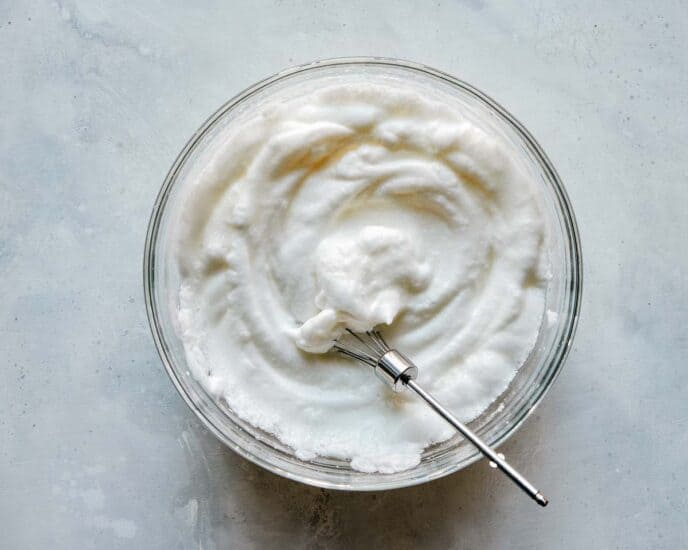 Egg white beaten in a bowl until soft peaks form.