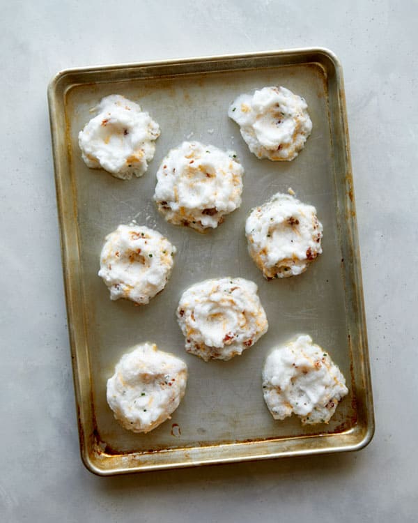 Egg clouds on a baking sheet ready to be baked.