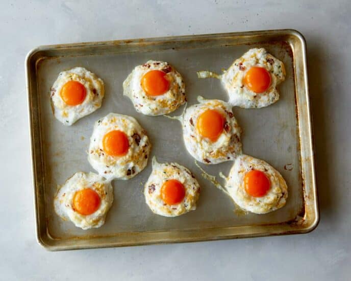 Egg clouds with egg yolks on a baking sheet. 