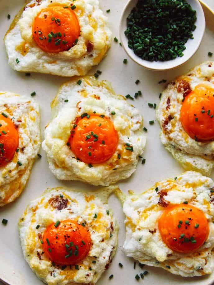 Cloud Eggs on a platter with slices chives.
