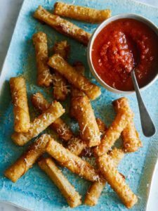 Mozzarella sticks with a marinara dipping sauce.