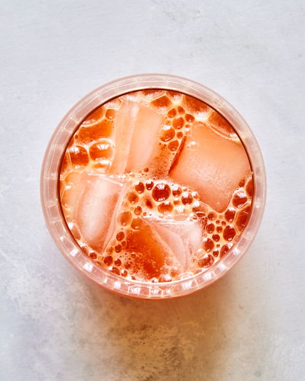 Blood orange shandy in a cocktail glass.