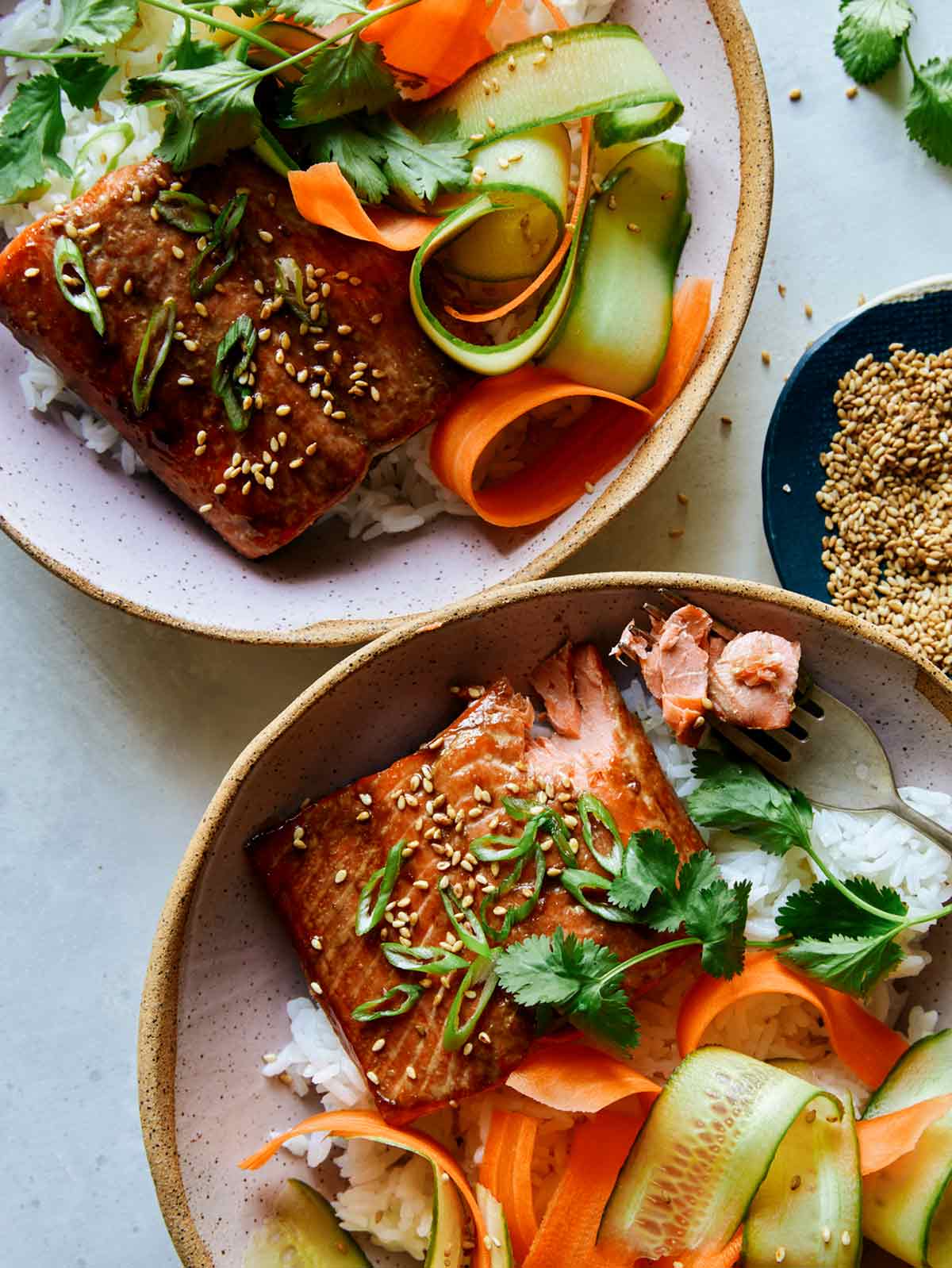 Teriyaki salmon dinner in two bowls. 