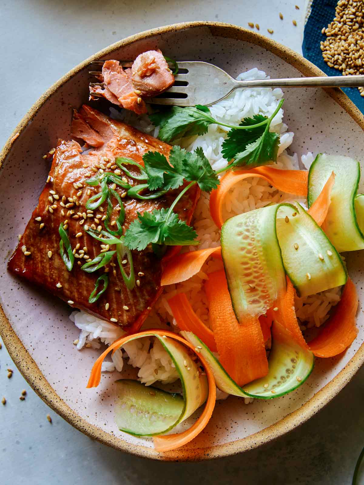 Teriyaki salmon recipe in a bowl with a fork. 