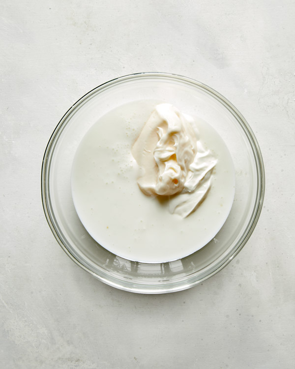 Ingredients for buttermilk ranch in a glass bowl.